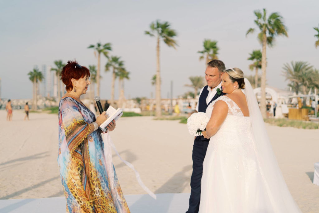 Theresa D Wedding Celebrant performing a wedding ceremony on the beach.