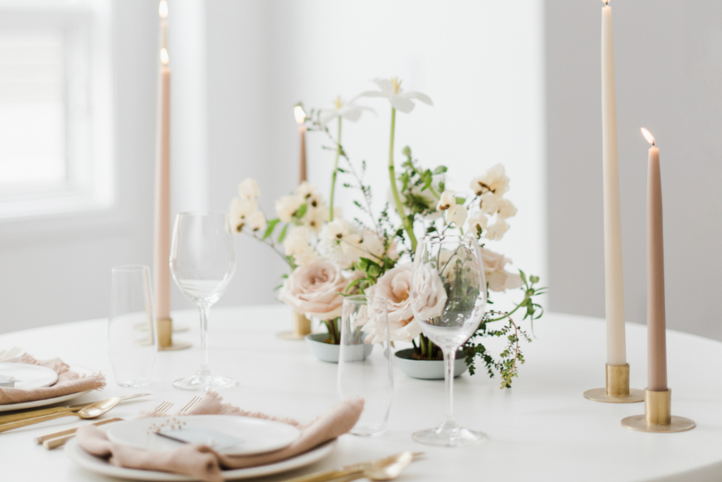 The Pros and Cons of Styled Shoots for Wedding Professionals. An inspiration of an elegant and minimal wedding tablescape in blush tones with taper candles, and two mini floral centerpieces in a flower frog (Japanese Kenzan).