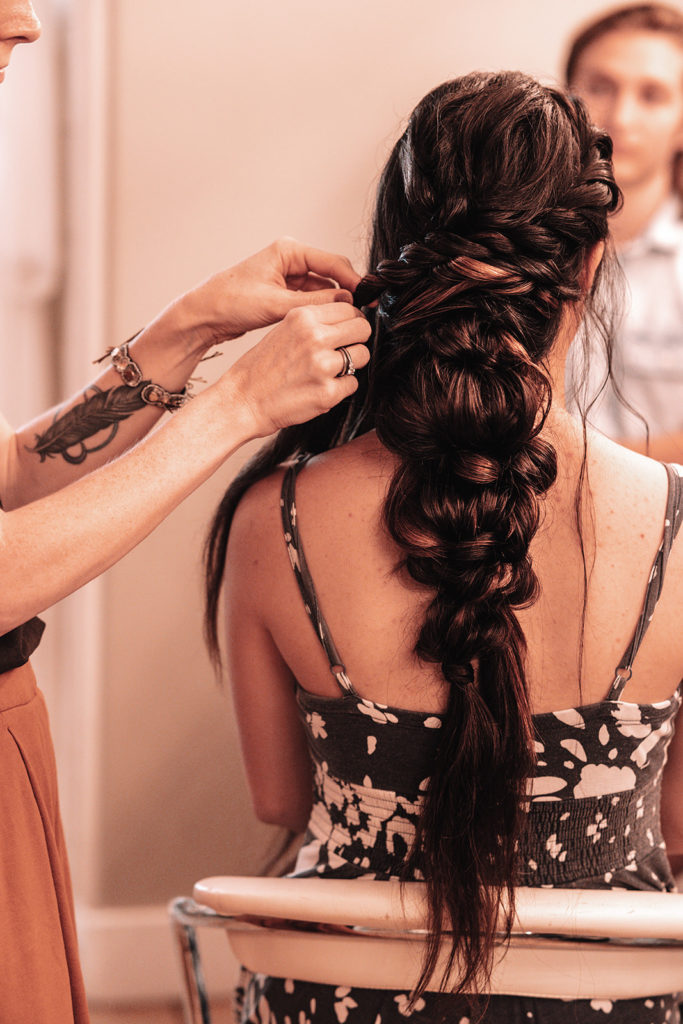 The Stylist Abroad, a destination wedding hairstylist, creates a voluminous braid for the bride.