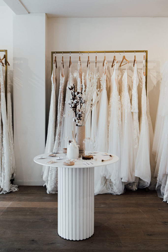 The interior of Modern Romance, a modern bridal boutique in Hilversum, the Netherlands. Gorgeous wedding and elopement dresses for the romantic, bohemian, and non-traditional bride hanging in the background. 
